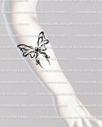 Small cybertribal bow tattoo on forearm, cute coquette ribbon design with neotribal heart and flame shapes, elegant feminine stencil. 