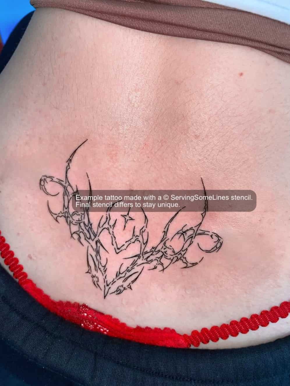 Small cyber sigil lower back tattoo results shown on skin using this stencil design, with a centered shape and subtle low-back placement.