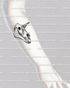 Small unicorn skull tattoo stencil displayed on forearm placement, detailed fine line skull with dripping horn gothic digital design.